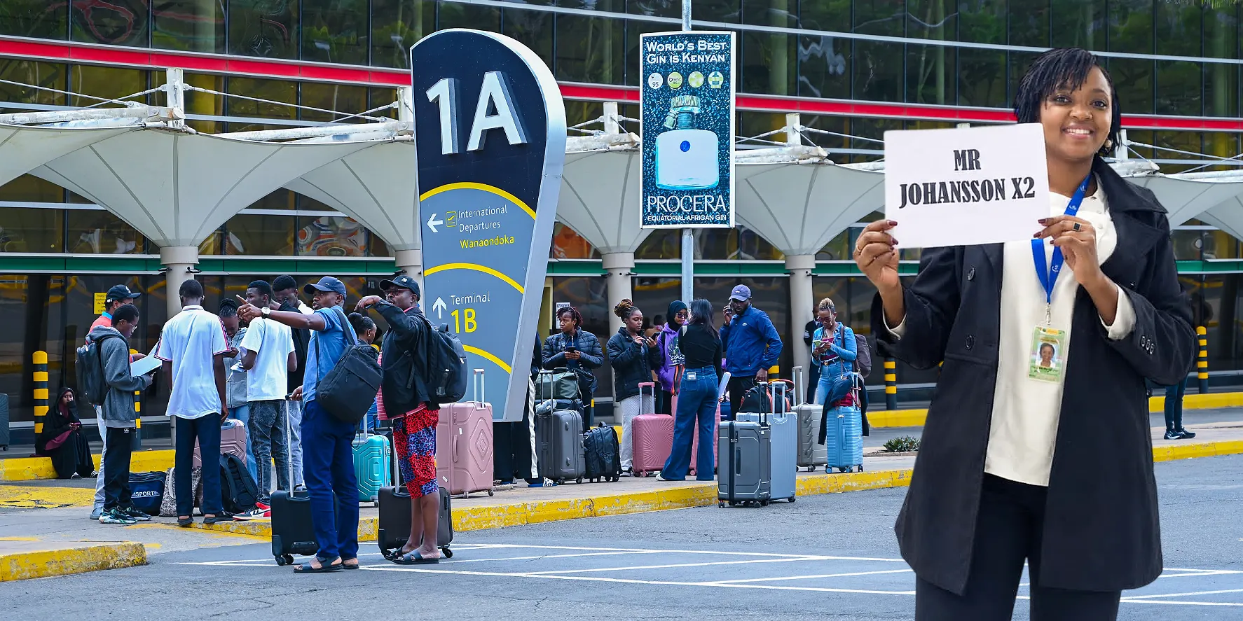Goodlife Holidays greeter holding an arrivals board at Jomo Kenyatta International Airport, next to a branded airport transfer vehicle