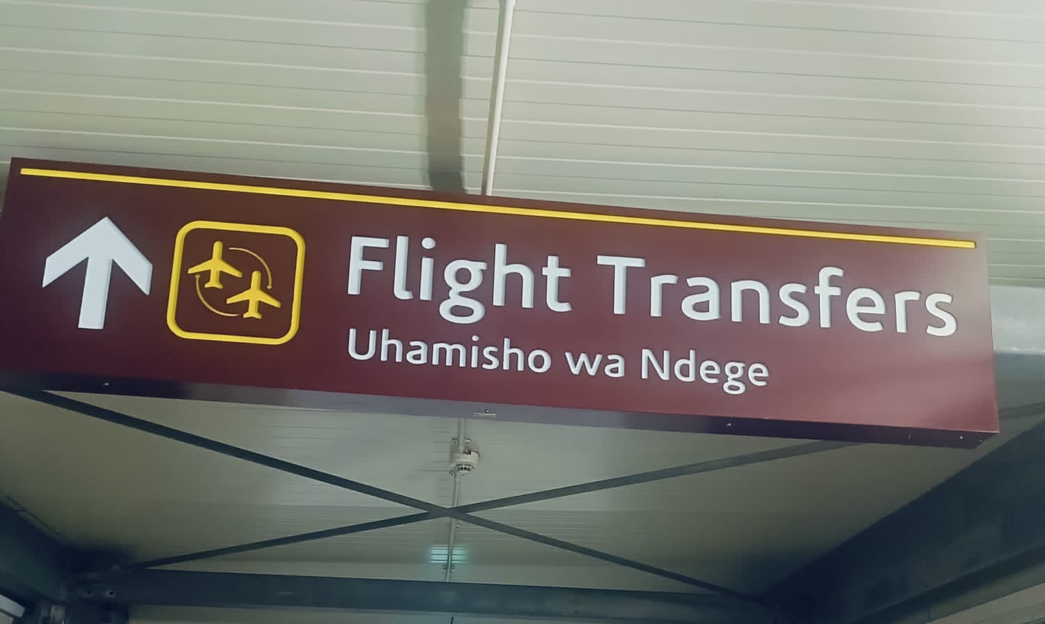 A transit passenger being walked to their onward gate at JKIA